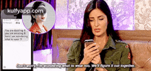 a woman is sitting on a couch looking at a cell phone and a text message .