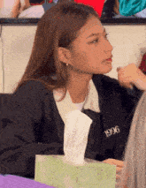 a woman wearing a black jacket with the year 1996 on the front