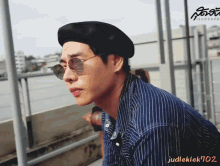 a man wearing a black beret and sunglasses has the name judleklek702 on the bottom
