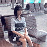 a woman is sitting on a chair with the name heyonjijoha on the bottom