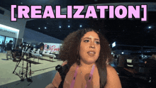a woman stands in front of a sign that says " realization "