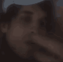 a blurry picture of a man wearing a white hat .