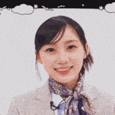 a woman wearing a purple scarf and a white jacket