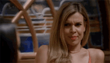 a close up of a woman making a funny face in a restaurant .