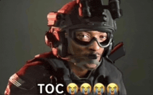 a man wearing a helmet and goggles has the word toc on the bottom