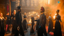 a group of people are dancing in front of a sign that says ' hotel '
