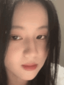 a close up of a woman 's face with a blurred background .