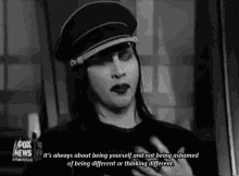 a black and white photo of marilyn manson with a caption that says it 's always about being yourself
