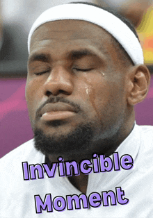 a man is crying with the words invincible moment written above him