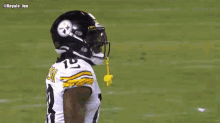 a football player holding a can of wild card