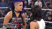 a woman with purple hair is wearing a shirt that says role model from the nxt