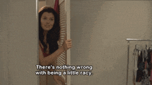 a woman peeking out of a closet with the words there 's nothing wrong with being a little racy