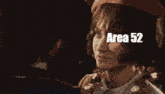 a group of people are walking down a street with area 52 written on the bottom