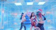 a group of women are dancing in a room with a lot of lights .