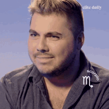 a man wearing a shirt with a scorpio sign on it