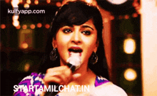 a woman with a spoon in her mouth and the words starttamilchat.in on the bottom