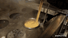 noodles are being poured into a container that says made in animotica on the bottom