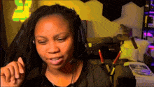 a woman wearing headphones and a microphone looks at something