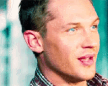 a close up of a man 's face with his mouth open and his eyes closed .