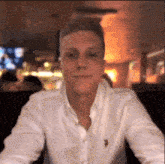 a man wearing a white shirt with a us polo assn logo on his chest