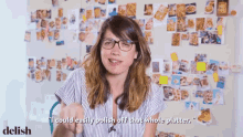 a woman says " i could easily polish off that whole platter " in front of a wall full of pictures