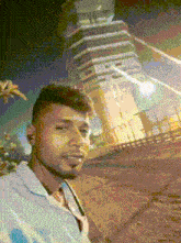 a man is taking a selfie in front of a tall building
