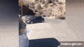 a black car is parked in a handicapped parking spot in a parking lot .