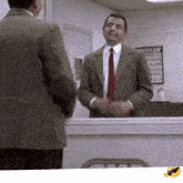 a man in a suit and tie stands in front of a mirror
