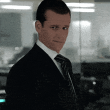 a man in a suit and tie is looking at something