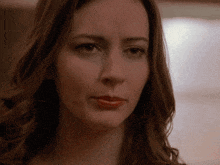 a close up of a woman 's face with a red lip