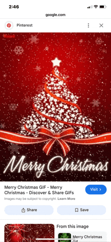 a phone screen shows a merry christmas greeting