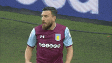 a man with a beard wears a purple and blue jersey with the word bwin on it