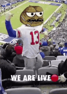 a new york giants mascot is dancing in the stands