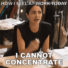 a woman sitting at a table with the words " i cannot concentrate " on the bottom