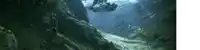 a waterfall is surrounded by mountains and trees in a canyon .