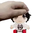a person is petting a stuffed animal that is sitting on a table .