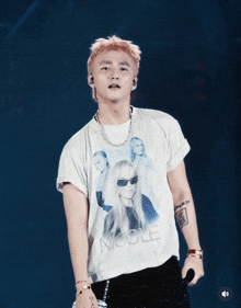 a man wearing a white t-shirt that says noble