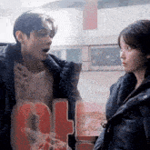 a man and a woman are standing next to each other with the number 9 visible in the background