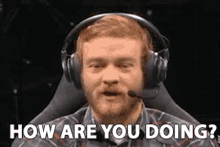 a man wearing headphones and a microphone is asking how are you doing