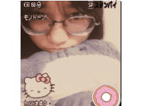 a girl wearing glasses and a hello kitty sticker