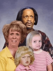a family posing for a picture with one child making a face