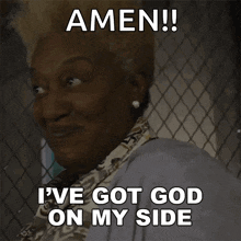 a woman behind a chain link fence is smiling and says amen i 've got god on my side