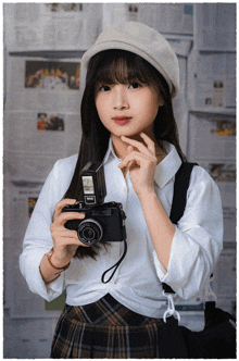 a girl holding a camera that says ' fujinon ' on the lens