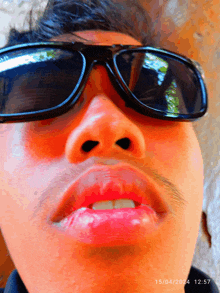 a close up of a man wearing sunglasses with the date 15/04/2024 12:57