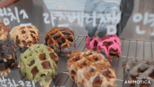 a variety of waffles are displayed in a display case with the words made in animatica on the bottom