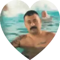 a man with a mustache is in a heart shaped swimming pool