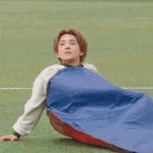 a person is standing next to a man laying on the ground .