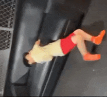 a person is doing a handstand on a trampoline in a gym .