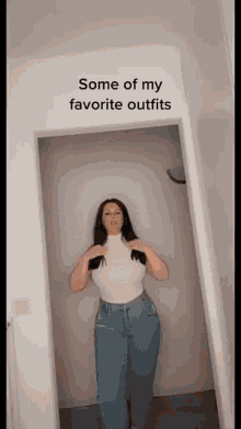 a woman is standing in a doorway wearing a white shirt and blue jeans .