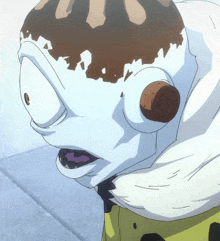 a close up of a cartoon character 's face with a cookie in it 's ear